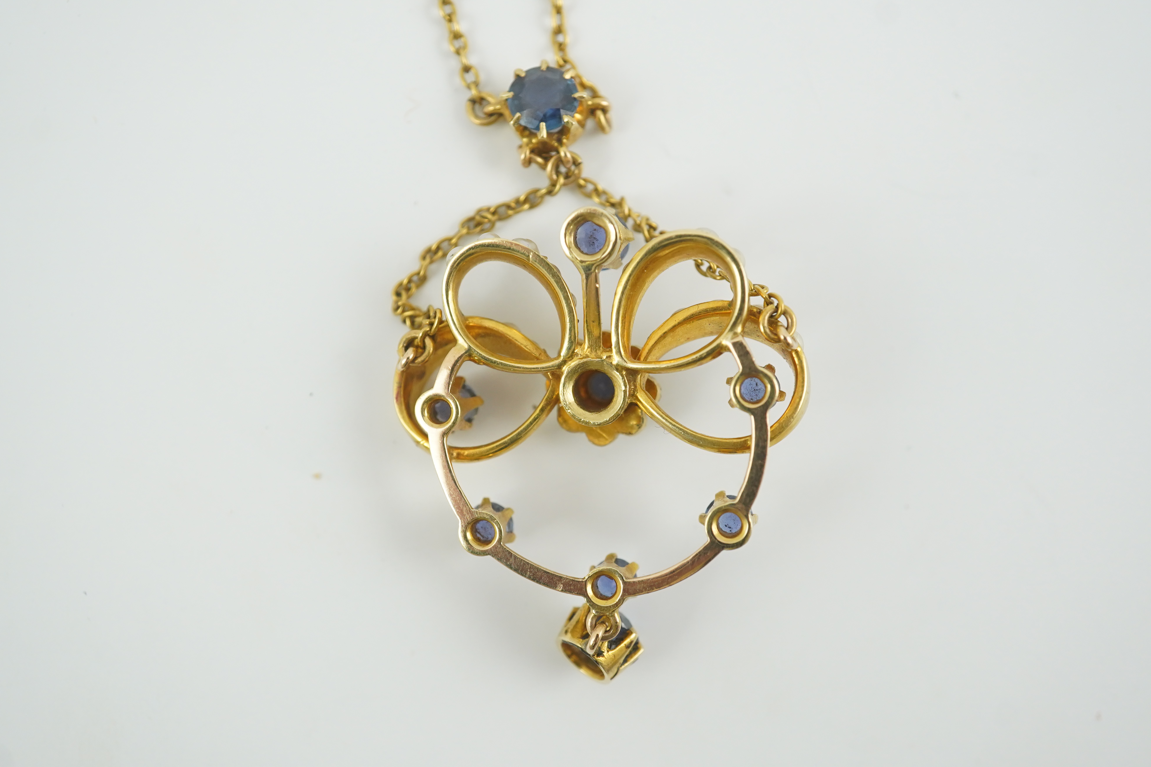 A mid 20th century gold, sapphire and seed pearl cluster set drop pendant necklace